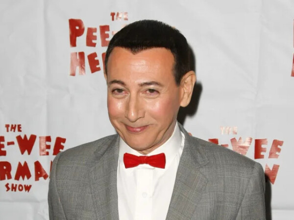 Paul Reubens, the American actor and comedian known for his famous children’s character Pee-wee Herman, has died aged 70.

Reubens died after living with cancer for years, a statement shared on his official Instagram account disclosed.

“Last night we said farewell to Paul Reubens, an iconic American actor, comedian, writer and producer whose beloved character Pee-wee Herman delighted generations of children and adults with his positivity, whimsy and belief in the importance of kindness,” the statement read.

It continued: “Paul bravely and privately fought cancer for years with his trademark tenacity and wit. A gifted and prolific talent, he will forever live in the comedy pantheon and in our hearts as a treasured friend and man of remarkable character and generosity of spirit.”

A separate slide on the social media post included a posthumous statement from Reubens himself, which read: “Please accept my apology for not going public with what I’ve been facing the last six years. I have always felt a huge amount of love and respect from my friends, fans and supporters. I have loved you all so much and enjoyed making art for you.”

A third slide urged those wishing to express their sympathy to do so in honour of Reubens’ late parents, Judy and Milton Rubenfeld, to Stand Up to Cancer or organisations involved in Dementia or Alzheimer’s care, support and research.

Reubens launched his career as a comedian and stage actor after joining the Los Angeles sketch troupe The Groundlings in 1978.

In 1982 he launched The Pee-wee Herman Show based on a character he had been developing for years. The stage show was a tremendous success and went on to spawn a 1985 film directed by Tim Burton, Pee-wee's Big Adventure.

The show was then adapted for television with Pee-wee's Playhouse, which ran on CBS from 1986 to 1991.

Also in 1991, Reubens’ career faced controversy for the first time – he was arrested for indecent exposure at an adult movie theatre in Florida.

Following the scandal, Reubens retreated from the public eye and did not appear in any major projects until 1999 when he made a comeback playing dramatic roles in films including Ted Demme's 2001 drama Blow, which starred Penélope Cruz and Johnny Depp.

In 2002; however, the comedian once again faced adversity after he was arrested and charged with misdemeanour possession of obscene material improperly depicting a child under the age of 18 in sexual conduct.

Two years later, the child pornography charge was dropped, with Reubens pleading guilty to a charge of obscenity instead.

“I probably have become more infamous from two misdemeanours than probably anyone I could think of,” Reubens told NBC at the time.

He claimed that he had amassed a huge collection of “vintage erotica” but was unaware that any of it could be interpreted as child pornography. He described the nude images as people “one hundred per cent not” performing sexual acts.

After 2006, Reubens made cameos and appearances in a number of projects including Reno 911! (2006), 30 Rock (2007), Pushing Daisies (2007), Life During Wartime (2009) and Accidental Love (2015).

In 2016, he co-wrote and starred in the Netflix original film Pee-wee’s Big Holiday, reprising his role as Pee-wee Herman.

Src: Yahoo News!